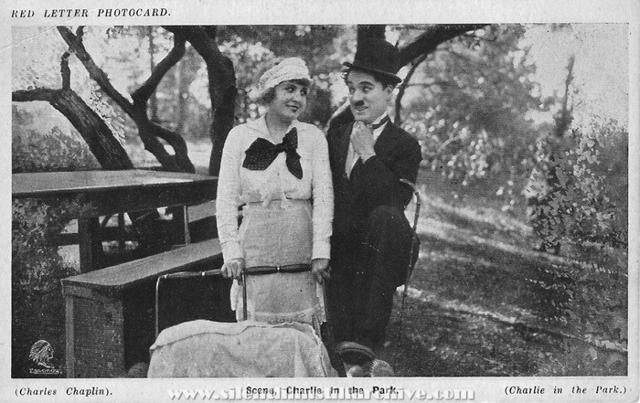 Red Letter Photocard for IN THE PARK (1915) with Edna Purviance and Charlie Chaplin