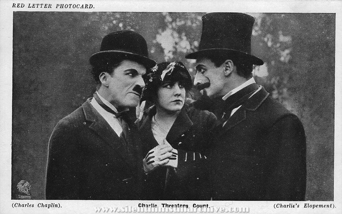 Red Letter Photocard of Charlie Chaplin, Edna Purviance, and Leo White
in A JITNEY ELOPEMENT (1915)