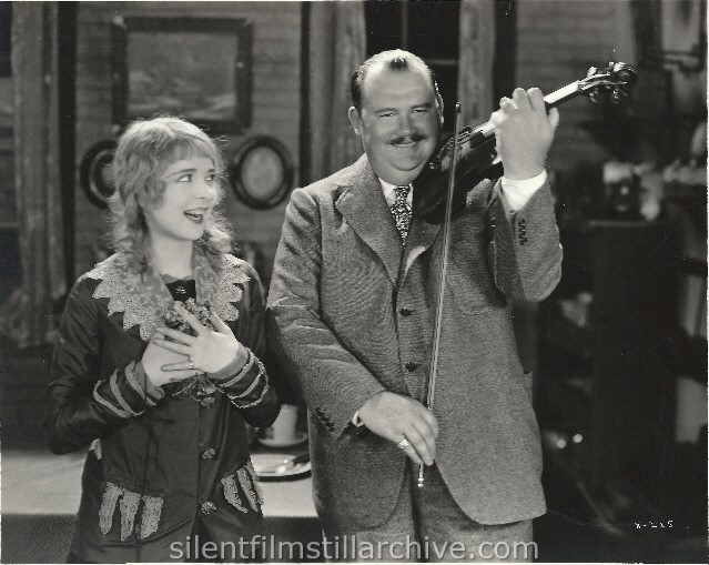 Colleen Moore, starring in "Twinkletoes," First National film, reacts to the violin solo rendered by Paul Whiteman, the eminent orchestra leader, composer and idol of American music fans. (1926)
