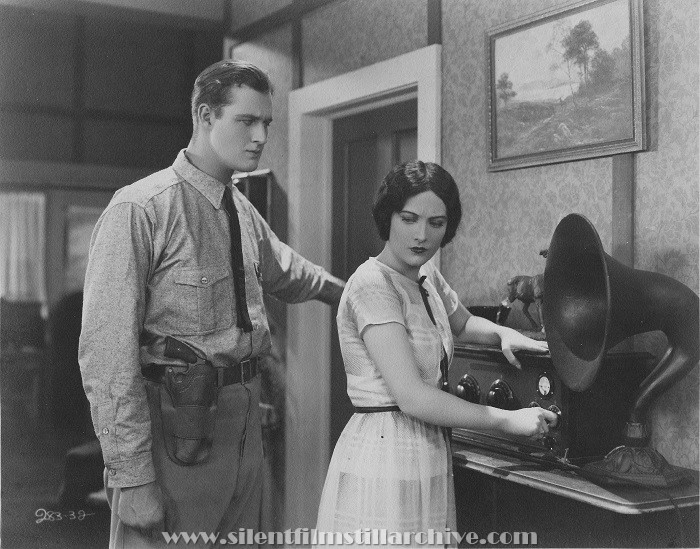 Francis X. Bushman, Jr. and Joan Crawford with radio in THE UNDERSTANDING HEART (1927).