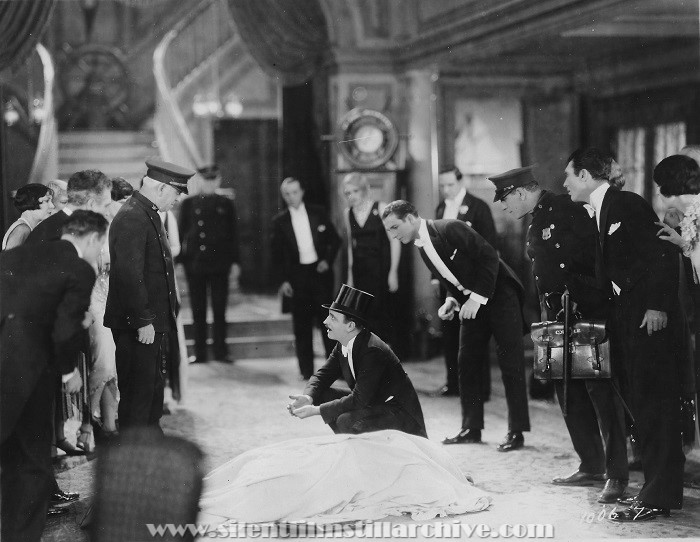 Tom McGuire (policeman at left), Raymond Griffith (squatting over body), and Earle Williams (in background center-left) in YOU'D BE SURPRISED (1926)