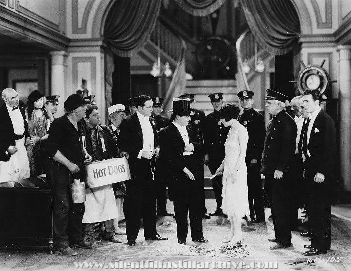 Jerry Mandy (with Hot Dog container), Monte Collins, Earle Williams, Raymond Griffith, Dorothy Sebastian, and Tom McGuire in YOU'D BE SURPRISED (1926).