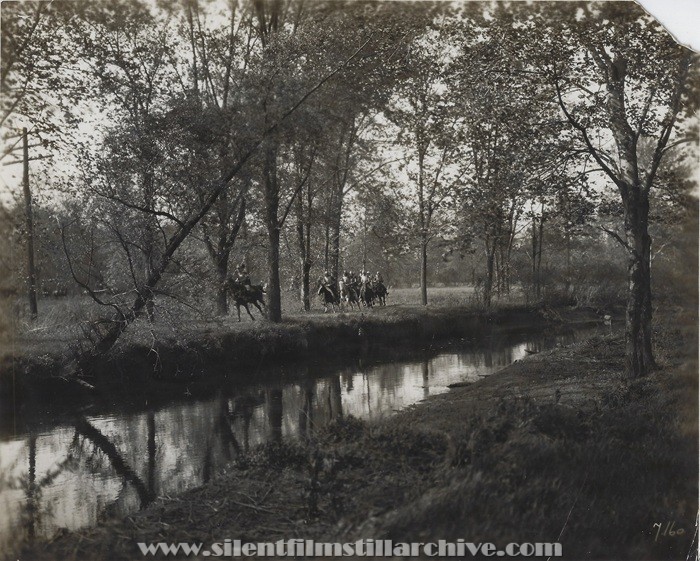 Soldiers ride ride horses in the forest in THE FIGHTING BLADE (1923)