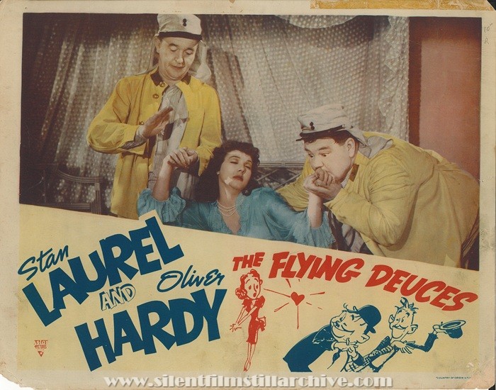 Lobby card for THE FLYING DEUCES (1939) with Stan Laurel, Jean Parker, and Oliver Hardy