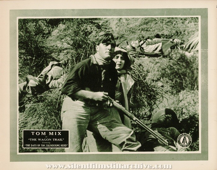 Lobby card for IN THE DAYS OF THE THUNDERING HERD (1914) with Tom Mix and Bessie Eyton